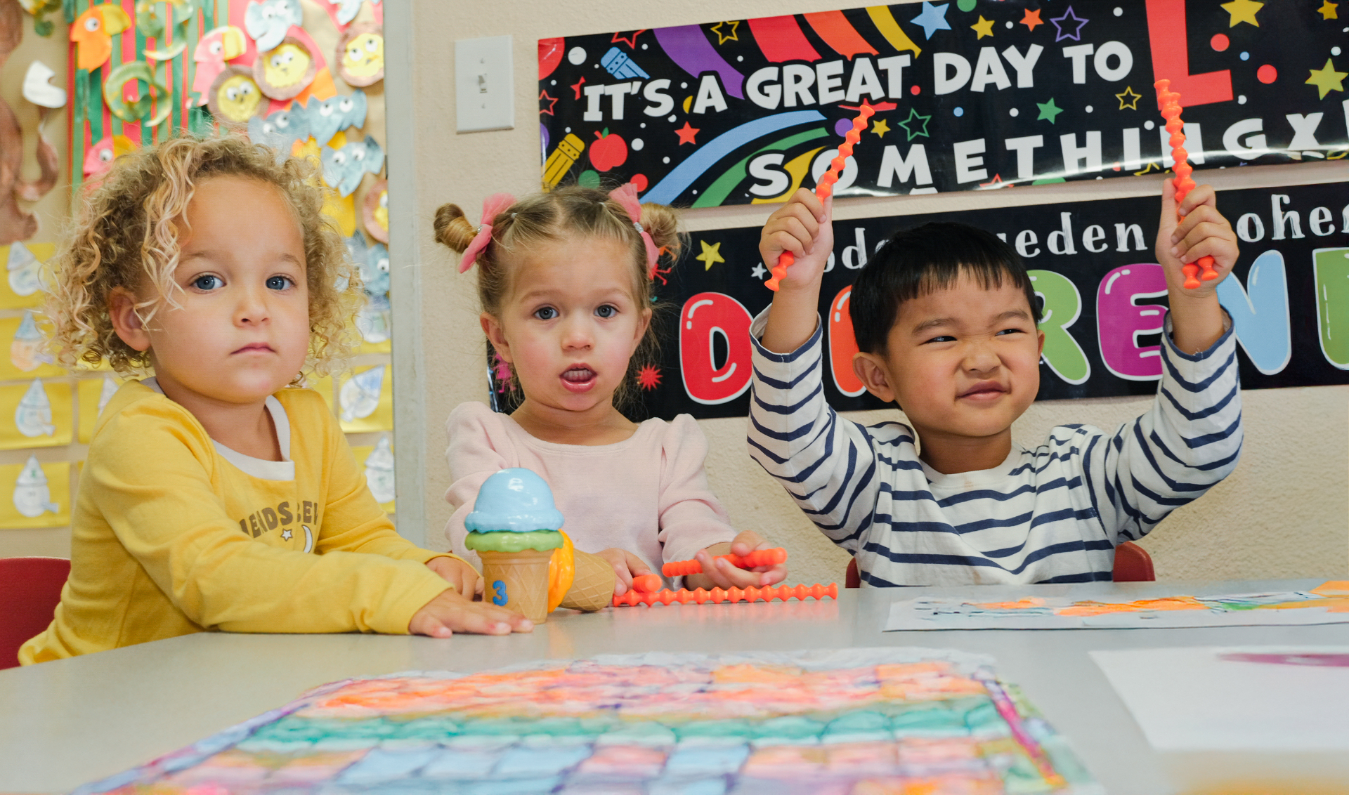 Happy children learning Spanish through play in a colorful classroom at Yak Academy in Redondo Beach